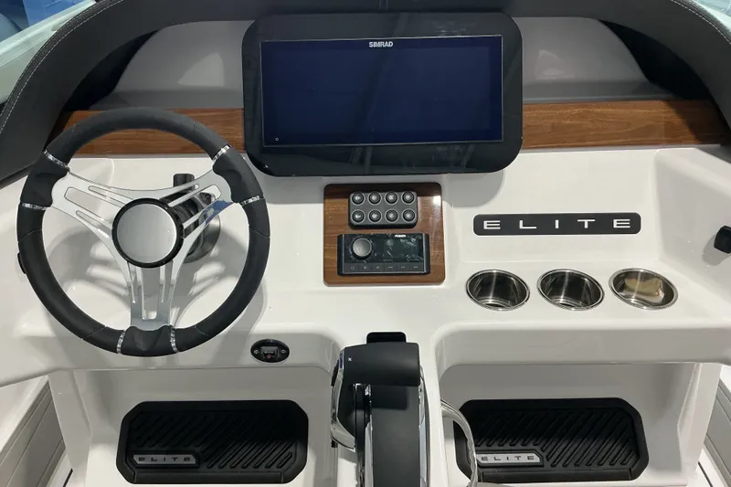 Slide: The Image of Cockpit of 2027 Monterey Elite 25 SD boat with steering wheel and control panel. - 16