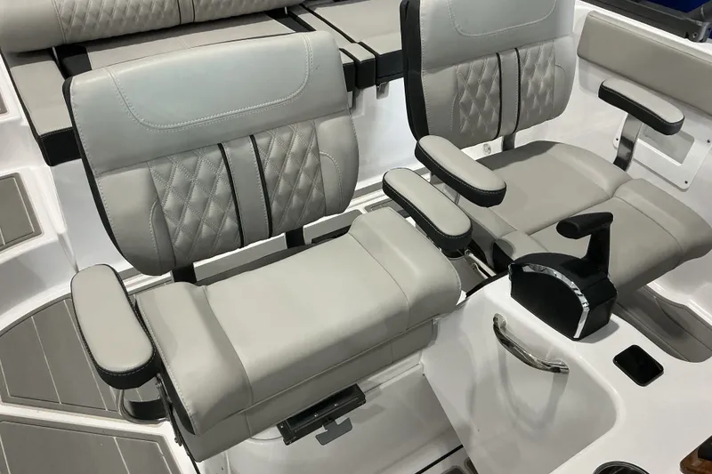 Slide: The Image of Luxurious seating on 2027 Monterey Elite 25 SD boat, featuring plush, adjustable armrests. - 14