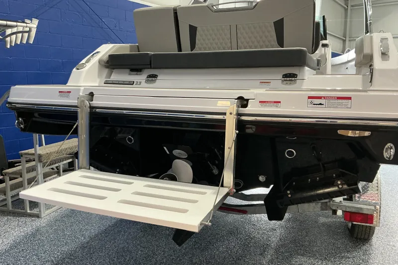 Slide: The Image of 2027 Monterey Elite 25 SD boat with extended swim platform in showroom. - 6