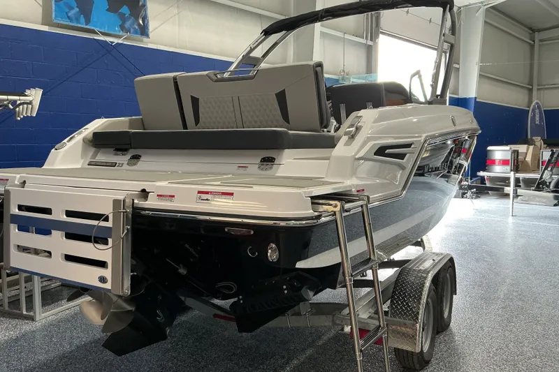 Slide: The Image of 2027 Monterey Elite 25 SD boat on trailer in showroom setting. - 3