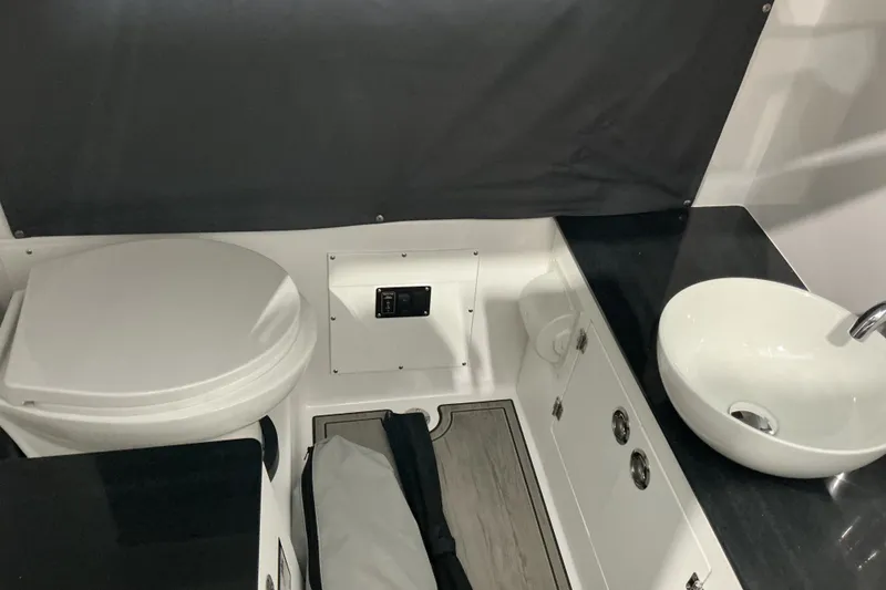 Slide: The Image of Bathroom interior of 2027 Monterey Elite 25 SD boat with toilet and sink. - 17