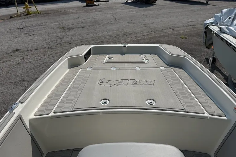 Slide: The Image of 2025 Mako Pro Skiff 17 CC boat deck, featuring non-slip surface and storage compartments. - 2
