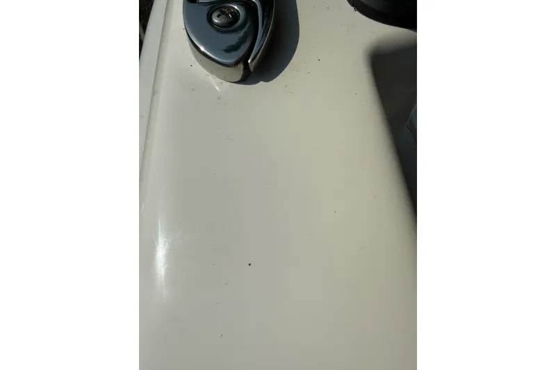 Slide: The Image of Close-up of a 2025 Mako Pro Skiff 17 CC boat surface with chrome detail. - 4