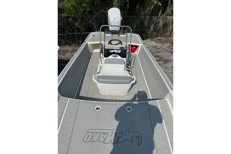 Slide: The Image of 2025 Mako Pro Skiff 17 CC boat interior with steering console and seating. - 3