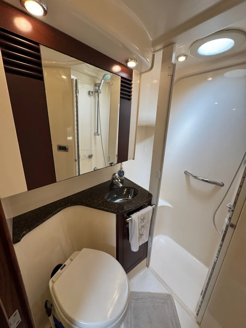 Slide: The Image of The bathroom of a 2007 Sea Ray 44 Sedan Bridge with sink, toilet, and shower. - 14