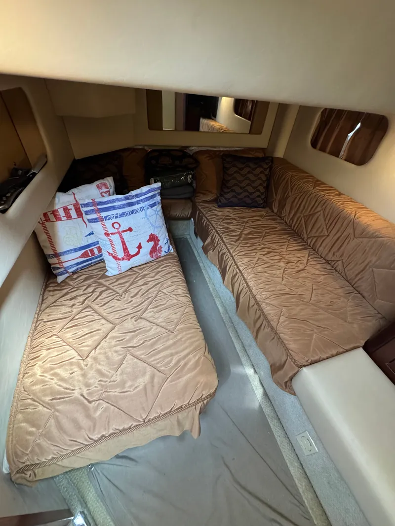 Slide: The Image of Interior of the 2007 Sea Ray 44 Sedan Bridge with two cushioned seating areas and decorative pillows. - 10