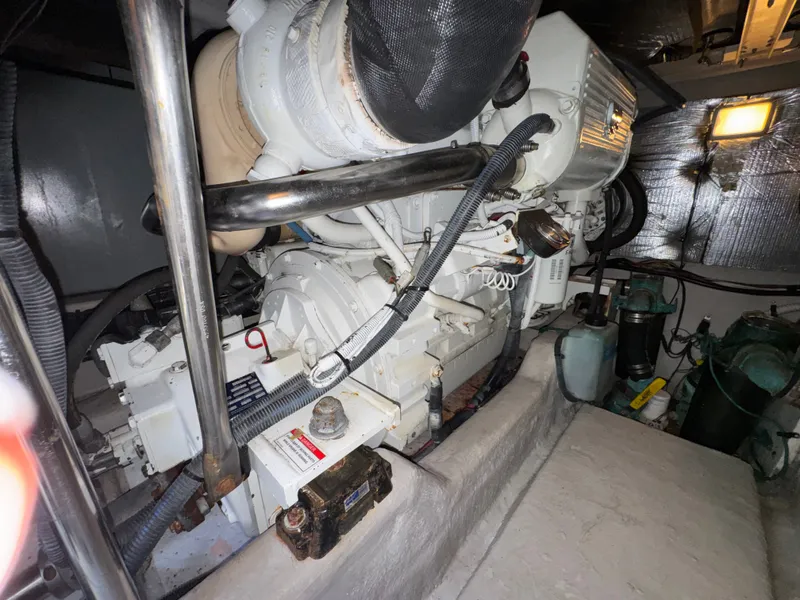 Slide: The Image of Engine room of the 2007 Sea Ray 44 Sedan Bridge with visible engine and piping. - 22