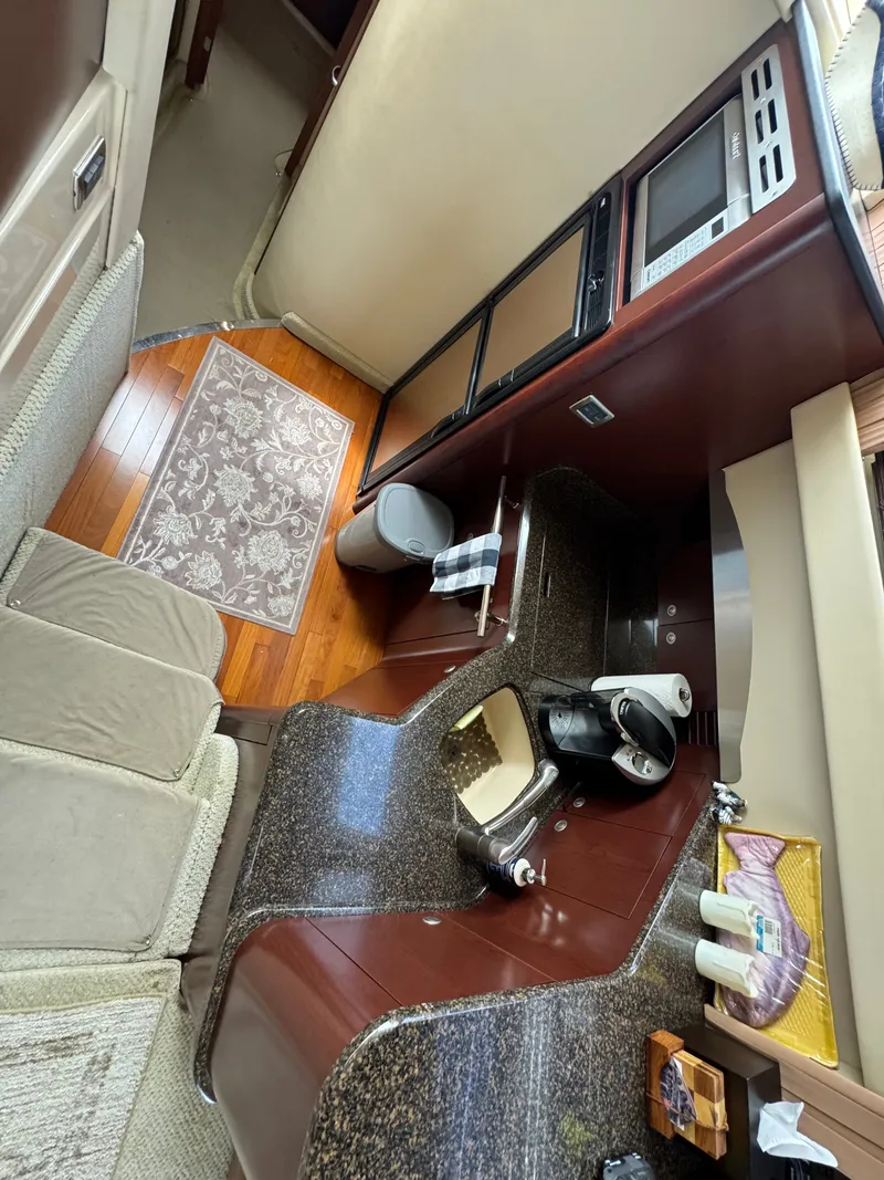 Slide: The Image of The galley of a 2007 Sea Ray 44 Sedan Bridge with granite countertops and modern appliances. - 7