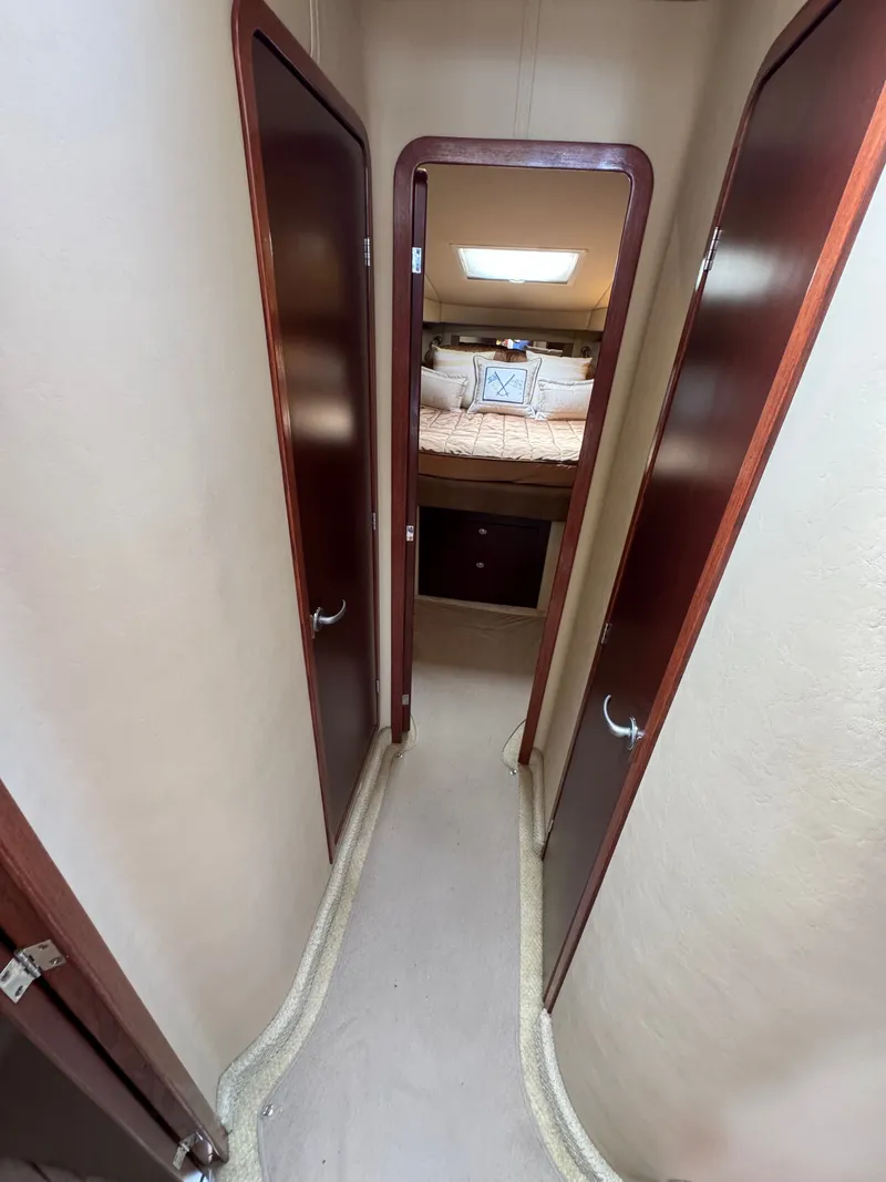 Slide: The Image of A narrow hallway with wooden doors leads to a cozy bedroom with a skylight. - 9