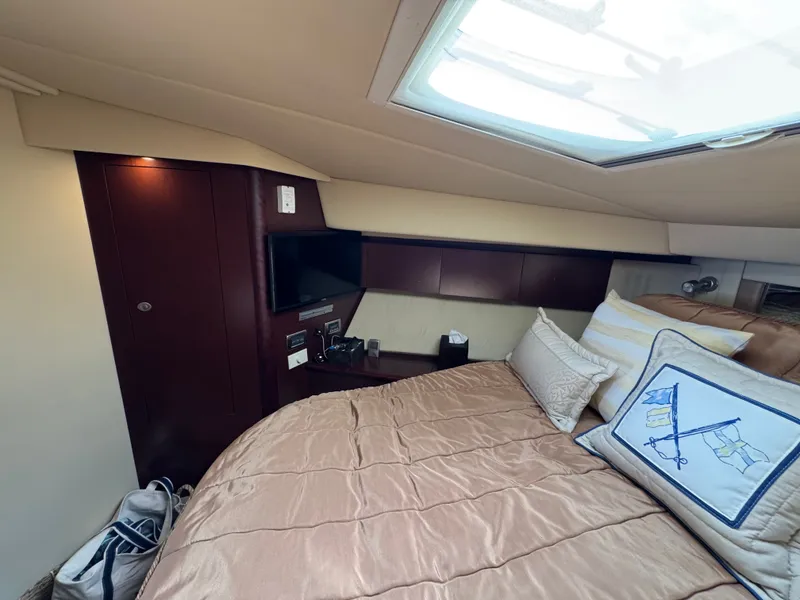 Slide: The Image of Cabin of the 2007 Sea Ray 44 Sedan Bridge with bed, pillows, and skylight. - 13