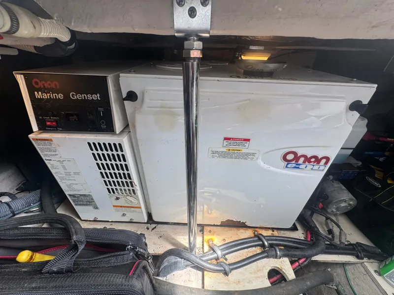 Slide: The Image of An Onan marine generator is installed in an engine room, surrounded by cables and metal structures. - 24