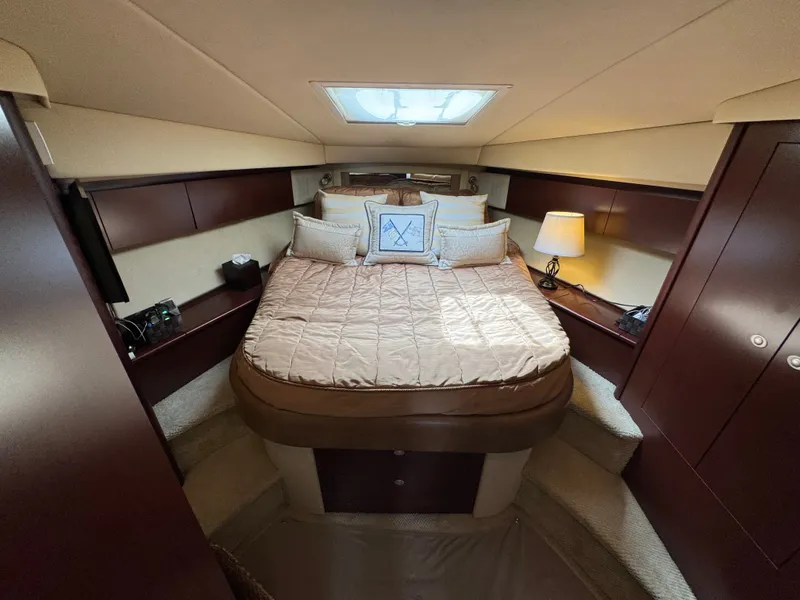 Slide: The Image of The image shows a cozy cabin with a double bed, surrounded by wood paneling and soft lighting. - 12