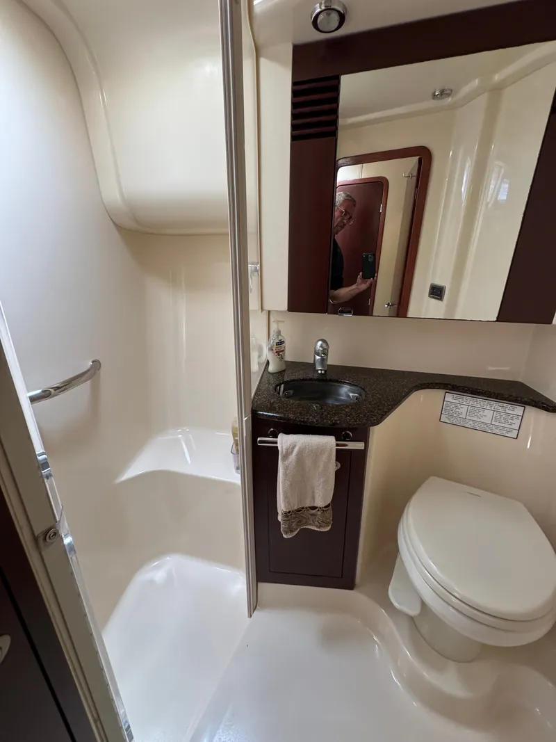 Slide: The Image of The image shows a boat bathroom with a shower, sink, and toilet. - 11