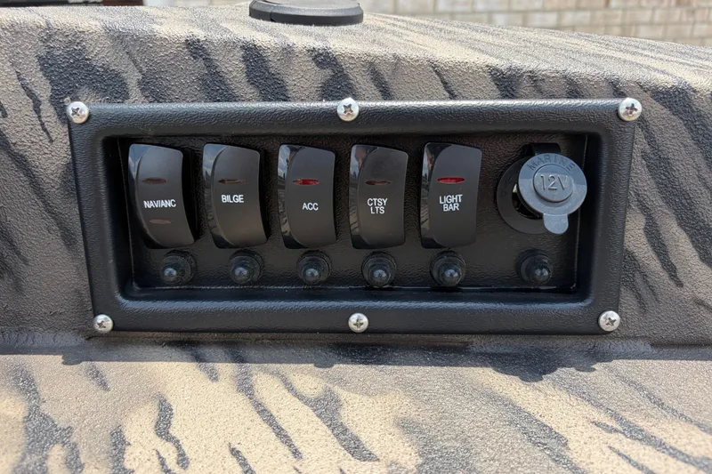 Slide: The Image of Control panel of 2026 Havoc 1756 DBST boat with switches and 12V outlet. - 10