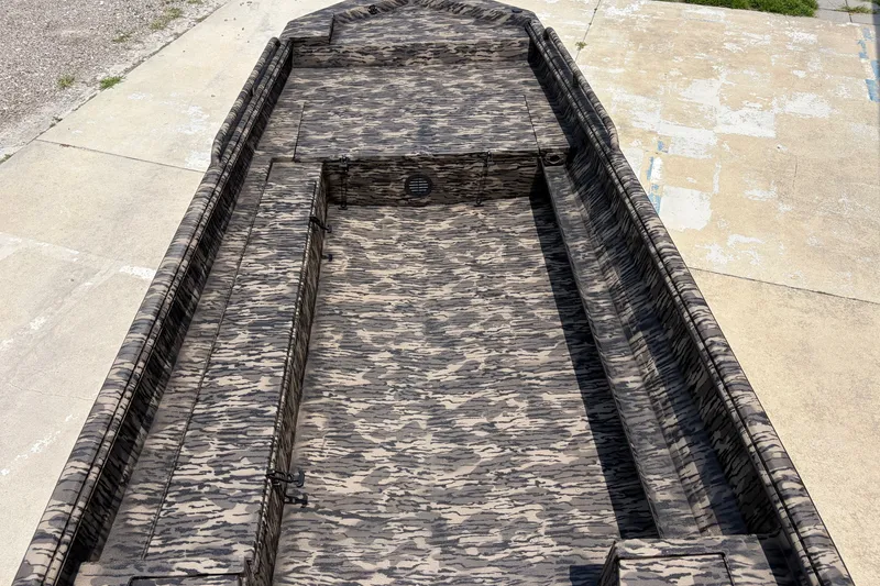 Slide: The Image of Camouflage-patterned interior of a 2026 Havoc 1756 DBST boat on concrete surface. - 12