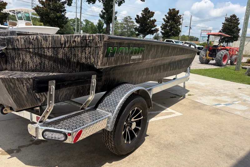 Slide: The Image of 2026 Havoc 1756 DBST boat on trailer, featuring camouflage design and sturdy build. - 4
