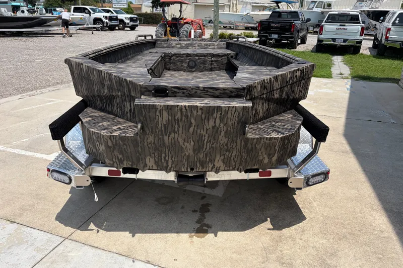 Slide: The Image of 2026 Havoc 1756 DBST boat on trailer, camo design, parked outdoors. - 3