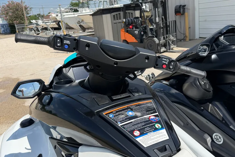Slide: The Image of 2024 Yamaha Waverunner handlebars and controls in a marina setting. - 9