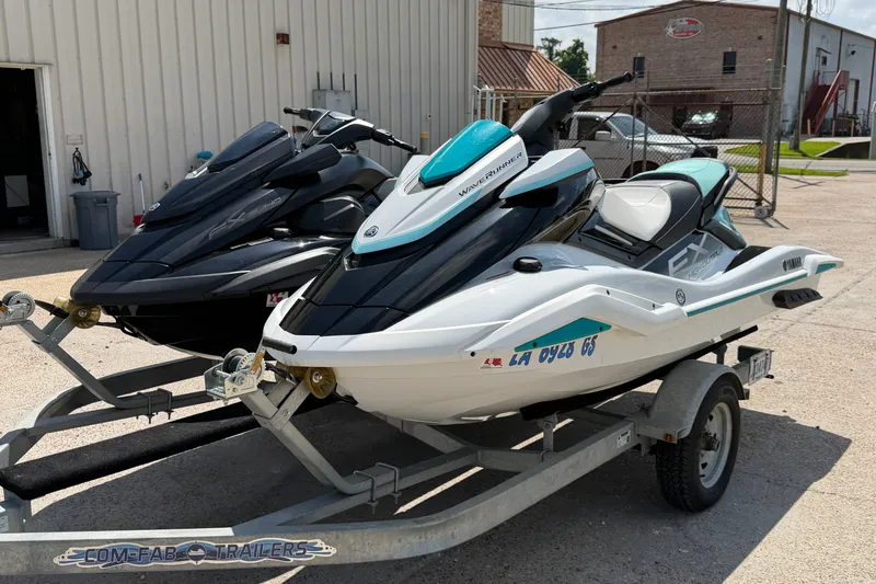 Slide: The Image of 2024 Yamaha Waverunner jet skis on trailer, parked outside a building. - 6
