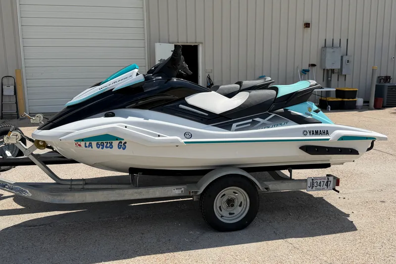 Slide: The Image of 2024 Yamaha Waverunner FX on trailer, parked outside a building. - 5