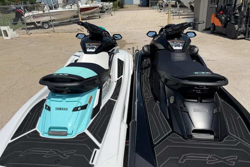 Slide: The Image of 2024 Yamaha Waverunner jet skis in teal and black, parked side by side outdoors. - 13