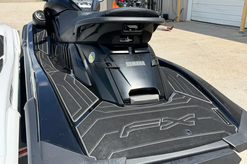 Slide: The Image of 2024 Yamaha Waverunner FX, black design, parked outdoors, showcasing rear deck and seat. - 11
