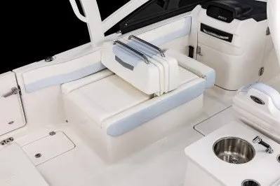 Slide: The Image of 2026 Robalo R257 Dual Console interior with seating and sink, showcasing modern design and functionality. - 6