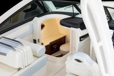 Slide: The Image of 2026 Robalo R257 Dual Console boat interior with seating and compact cabin space. - 9