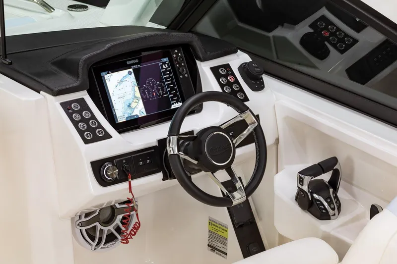 Slide: The Image of Manufacturer Provided Image: 2025 Robalo R257 Dual Console boat dashboard with steering wheel and navigation display. - 11