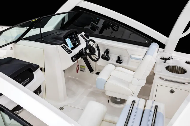 Slide: The Image of Manufacturer Provided Image: 2025 Robalo R257 Dual Console boat interior with modern helm and seating. - 10