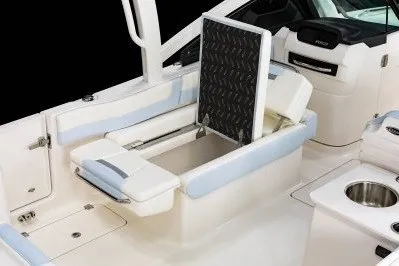 Slide: The Image of 2026 Robalo R257 Dual Console boat interior with storage compartment open. - 8