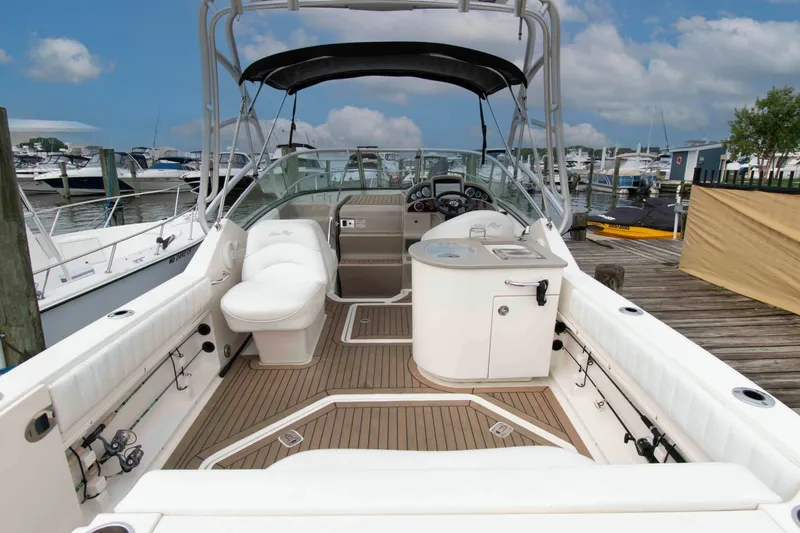 Slide: The Image of 2007 Sea Ray 270 Amberjack boat interior with seating and helm, docked at marina. - 1