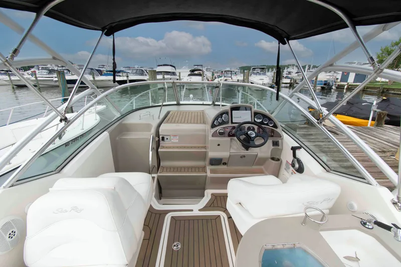 Slide: The Image of 2007 Sea Ray 270 Amberjack boat interior with helm, docked at marina. - 4