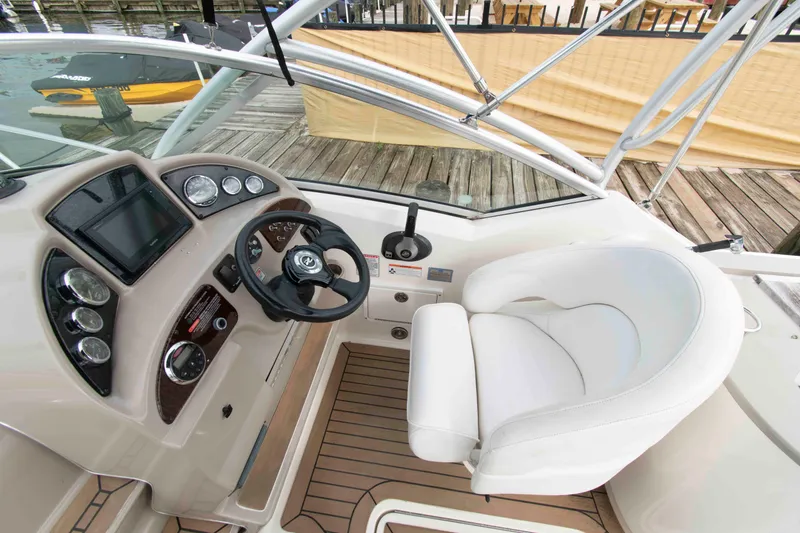 Slide: The Image of Cockpit of 2007 Sea Ray 270 Amberjack with steering wheel and control panel. - 5