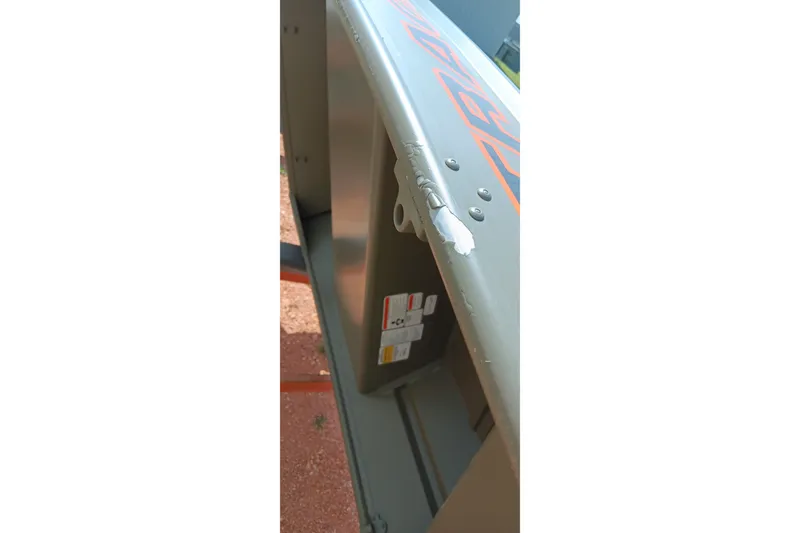 Slide: The Image of 2026 Tracker Grizzly 10 Jon boat with visible paint damage on the side. - 7