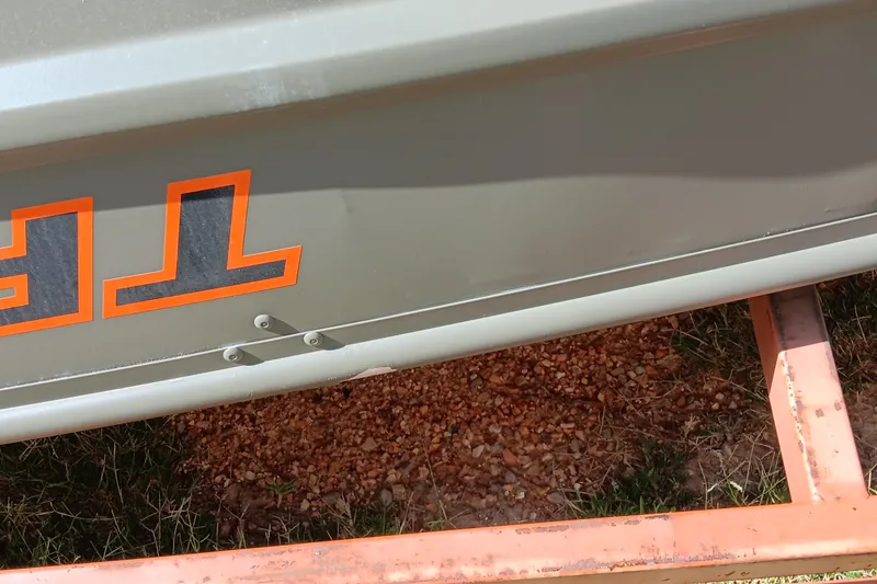 Slide: The Image of 2026 Tracker Grizzly 10 Jon boat on trailer, close-up view. - 5