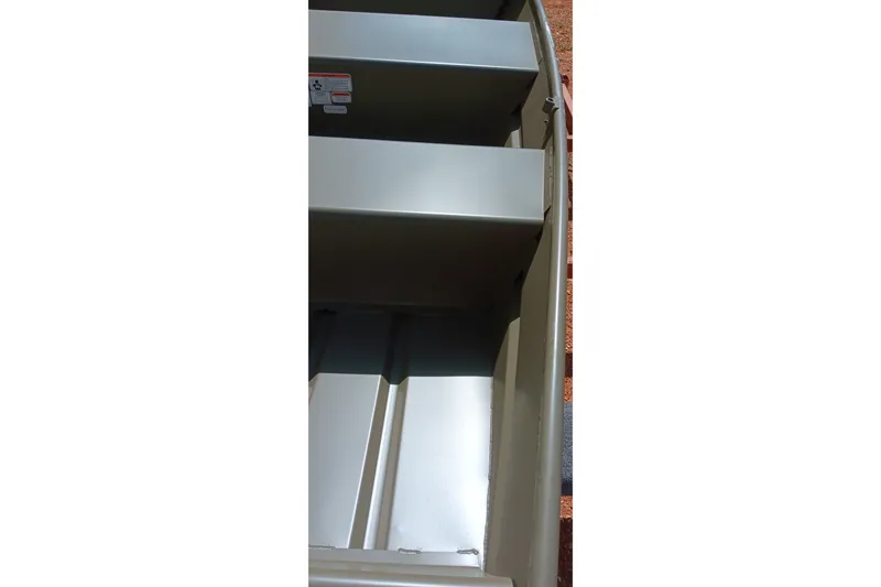 Slide: The Image of 2026 Tracker Grizzly 10 Jon boat interior with bench seats and metal flooring. - 9