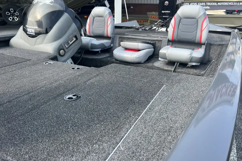 Slide: The Image of 2016 Tracker Pro Team 195 TXW boat interior with gray seating and carpeted deck. - 4