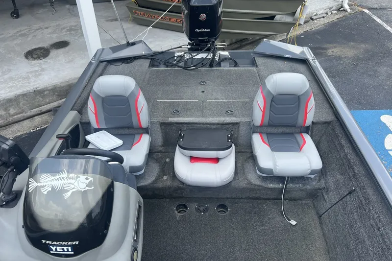Slide: The Image of 2016 Tracker Pro Team 195 TXW boat interior with gray and red seating. - 7