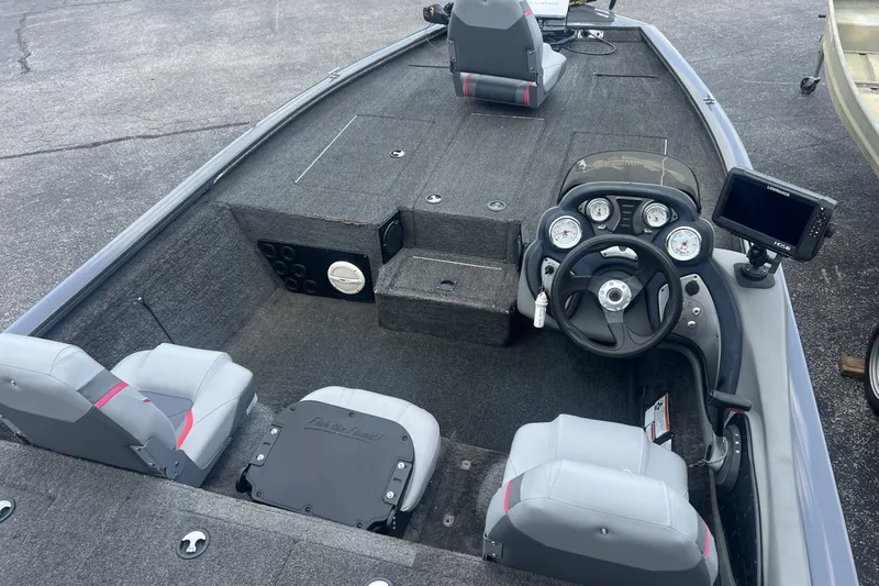 Slide: The Image of 2016 Tracker Pro Team 195 TXW boat interior with steering console and seating. - 3