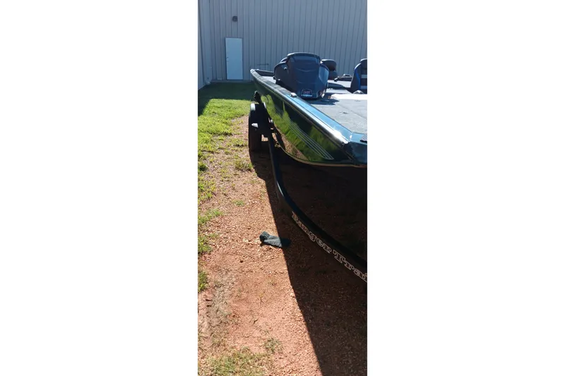 Slide: The Image of 2026 Ranger RT198P boat parked on gravel near a building. - 14