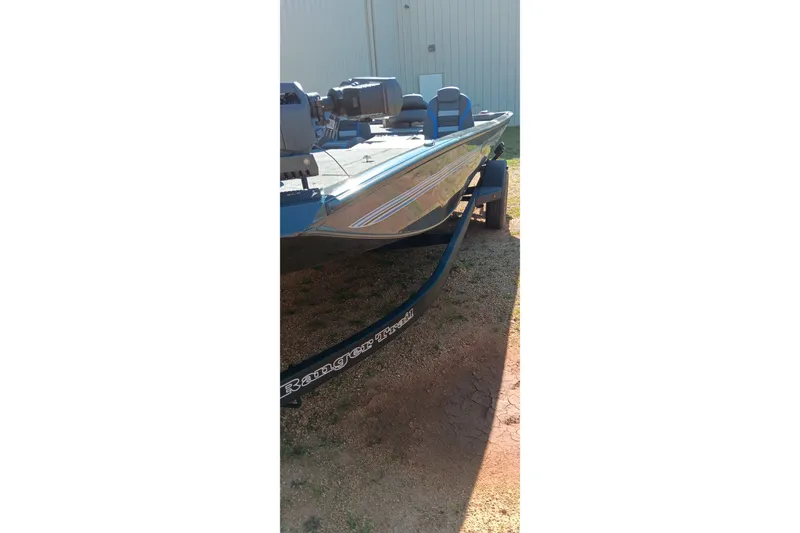 Slide: The Image of 2026 Ranger RT198P boat on trailer, parked outdoors in sunlight. - 13