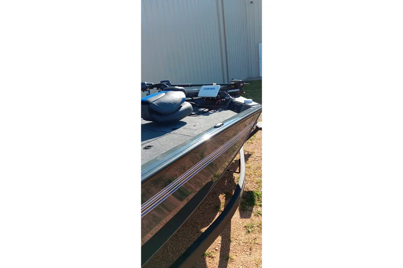 Slide: The Image of 2026 Ranger RT198P boat with Lowrance electronics, parked outdoors. - 6