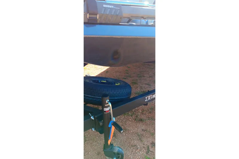 Slide: The Image of 2026 Ranger RT198P boat trailer with spare tire on gravel surface. - 12