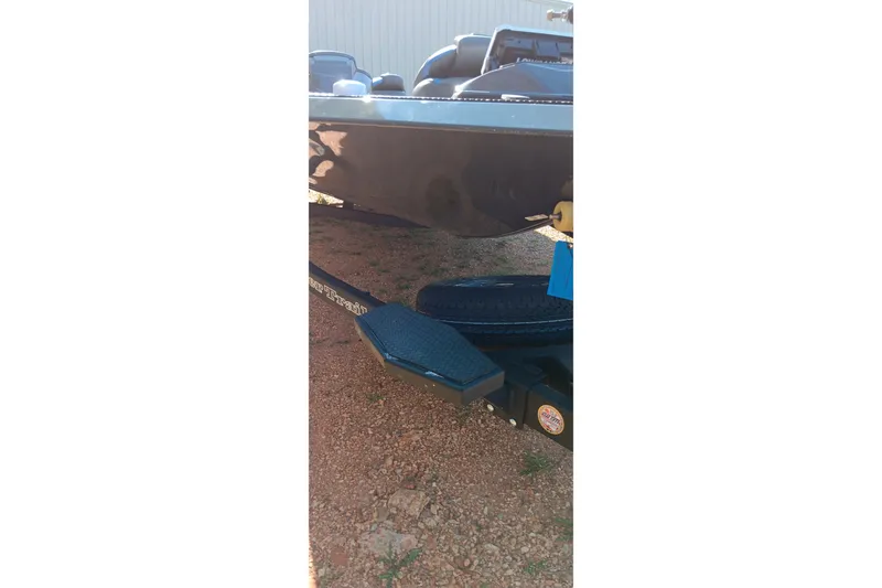 Slide: The Image of 2026 Ranger RT198P boat trailer on gravel surface, close-up view. - 11