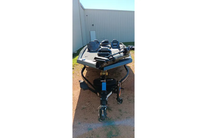 Slide: The Image of 2026 Ranger RT198P boat on trailer, parked outdoors near a building. - 10