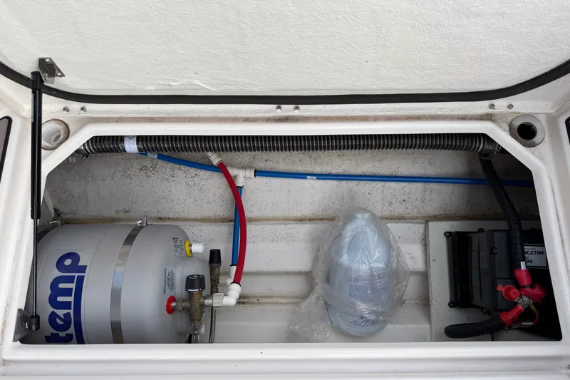 Slide: The Image of 2024 Cutwater C-248 Coupe engine compartment with wiring and water heater components. - 32