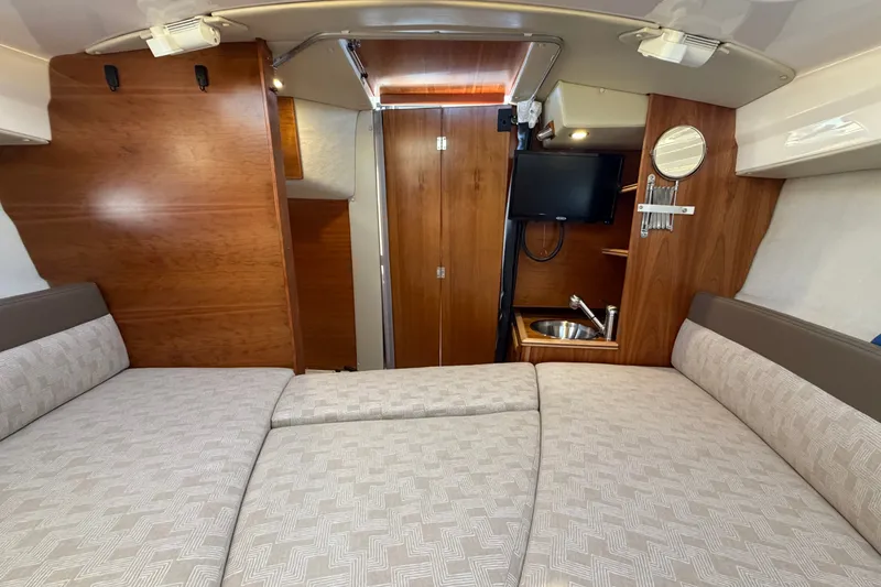 Slide: The Image of 2024 Cutwater C-248 Coupe interior with bed, TV, and sink. - 20