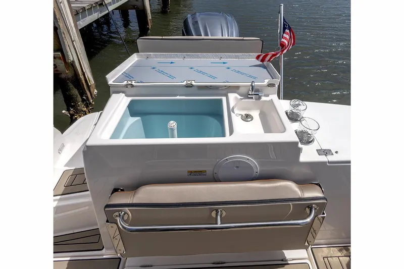 Slide: The Image of Manufacturer Provided Image: 2024 Cutwater C-248 Coupe boat with open storage compartments and American flag. - 24