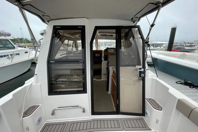 Slide: The Image of 2024 Cutwater C-248 Coupe boat interior view at marina dock. - 7